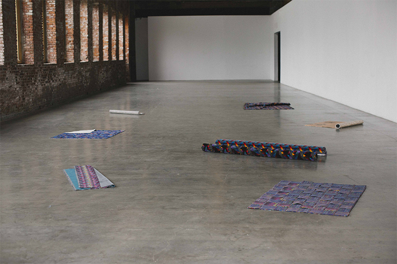Installation view at Pioneer Works of Street Corner, 117th and Wentworth Ave, Carpetbagger and other works, 2015 Synthetic carpet, resin, stucco, cement, seating upholstery, chewing gum Variable dimensions
